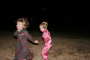 Between Fireworks The kids ran like crazy in the front yard inbetween the big fireworks. Carlie and I cowered in fear behind some bushes.