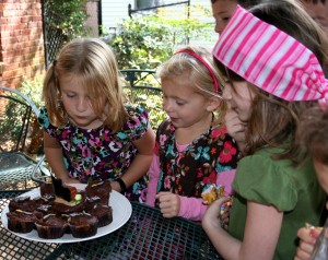 Tiller blowing out her candle as Sydney and Chloe look on.