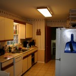 You come in the kitchen door, and here is this long-ass narrow, almond-colored monstrosity of a kitchen.